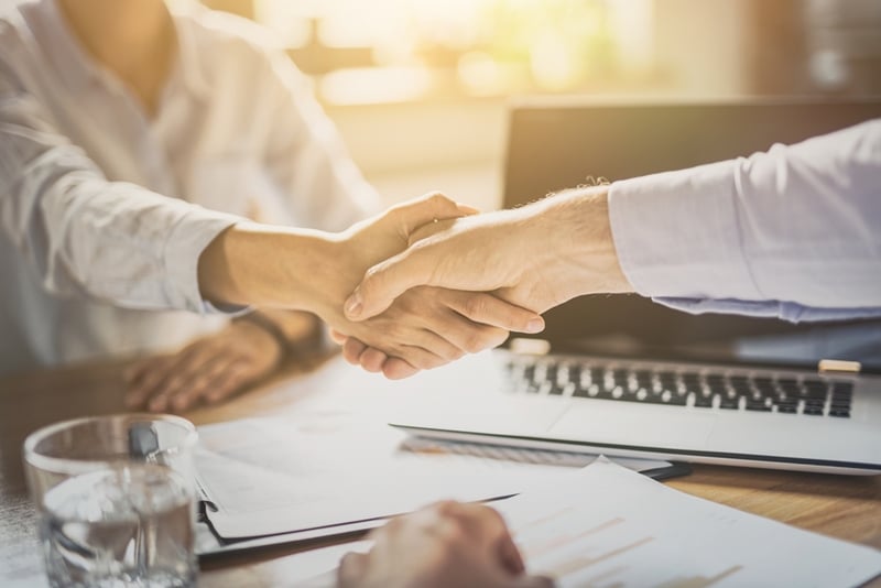 Borrower shaking hands with specialist lending broker.